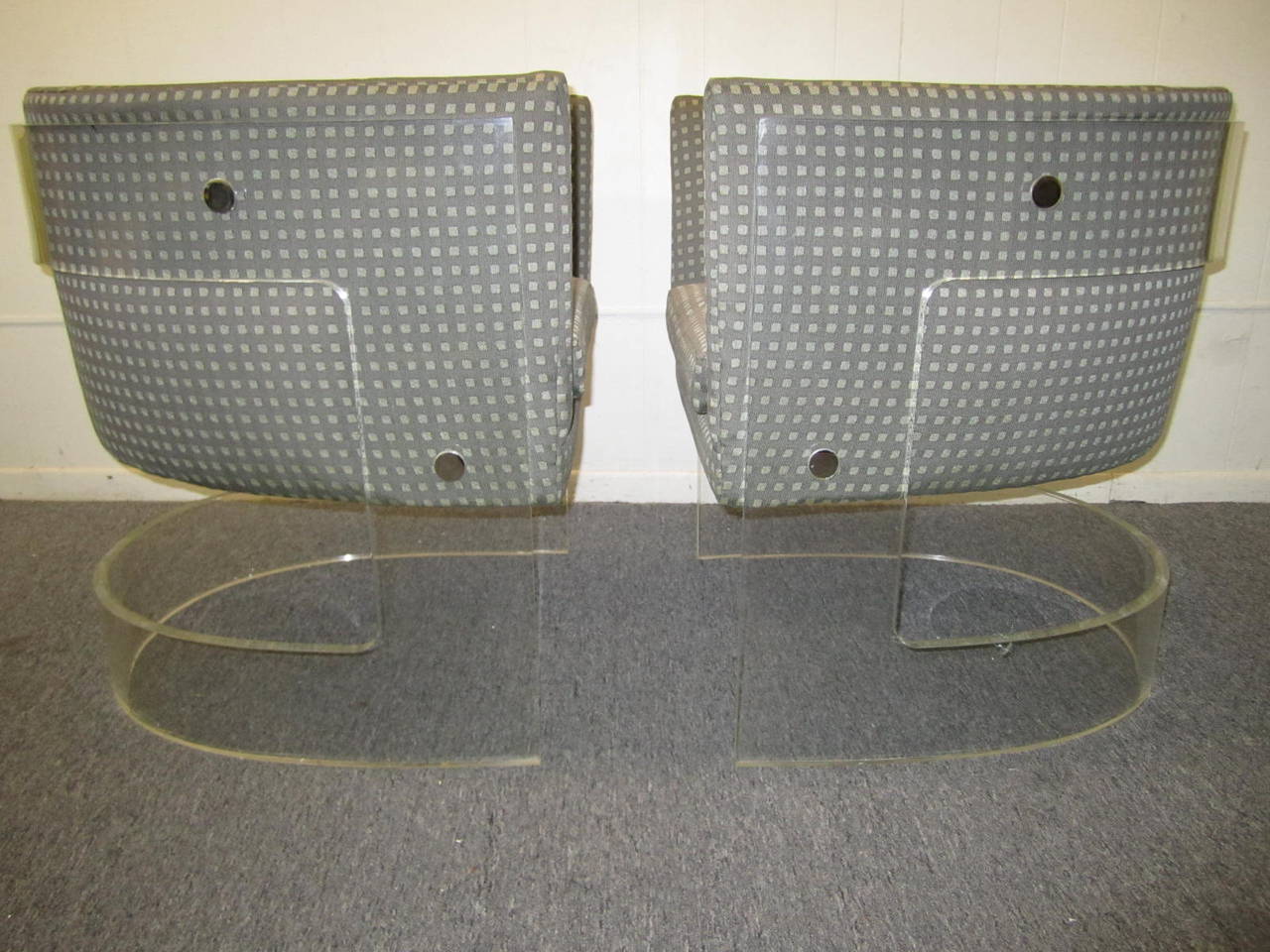 Stunning pair of Milo Baughman thick Lucite barrel back chairs. These rare and magnificent chairs are in excellent vintage condition and are sure to please.