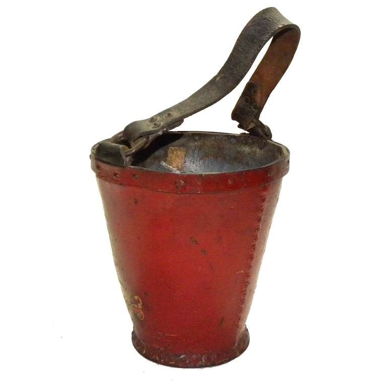 English red leather fire bucket.
 With leather handle and centrally emblazoned with the English Royal Coat of Arms.