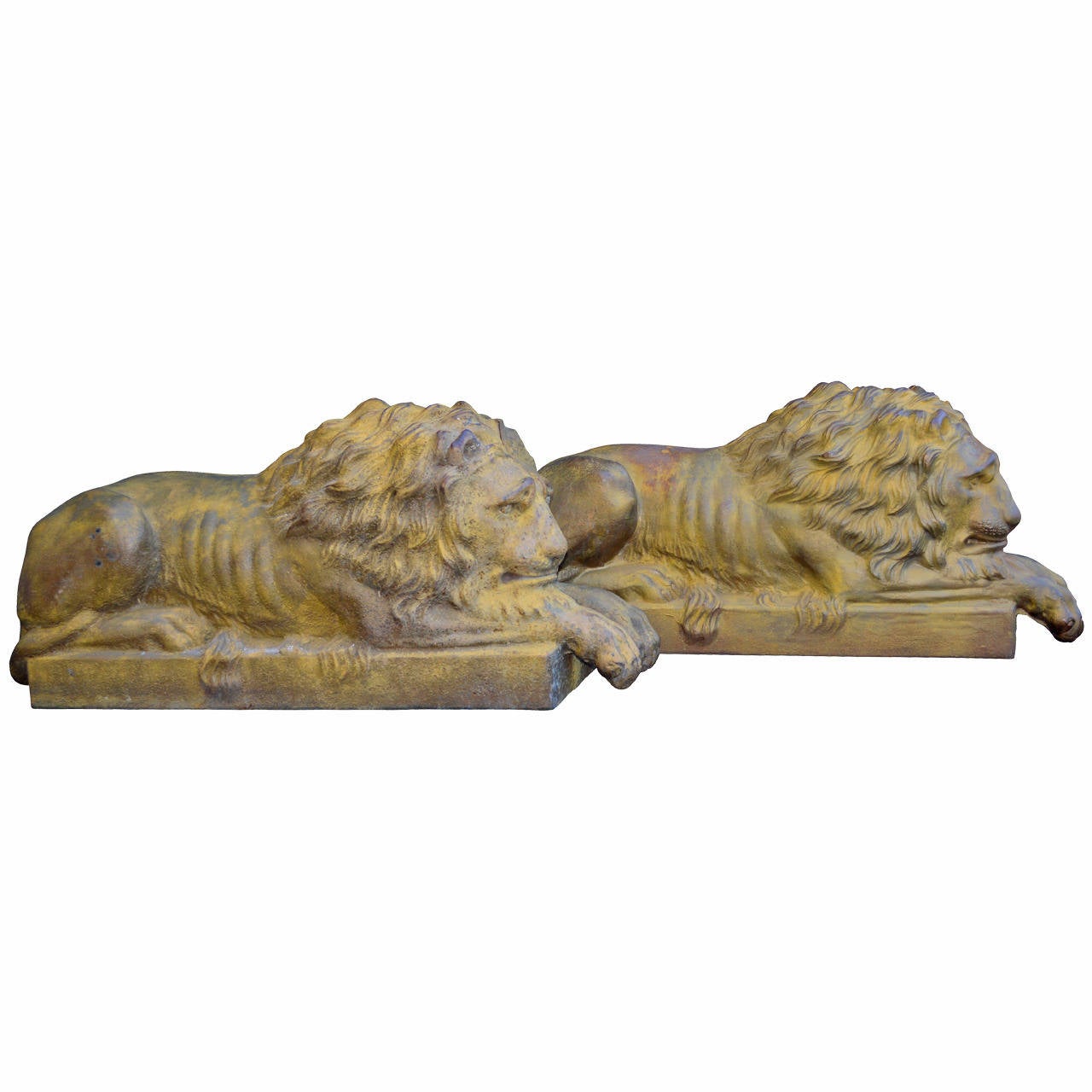 Two large resting lions on cast iron base with worn original colors of yellow.