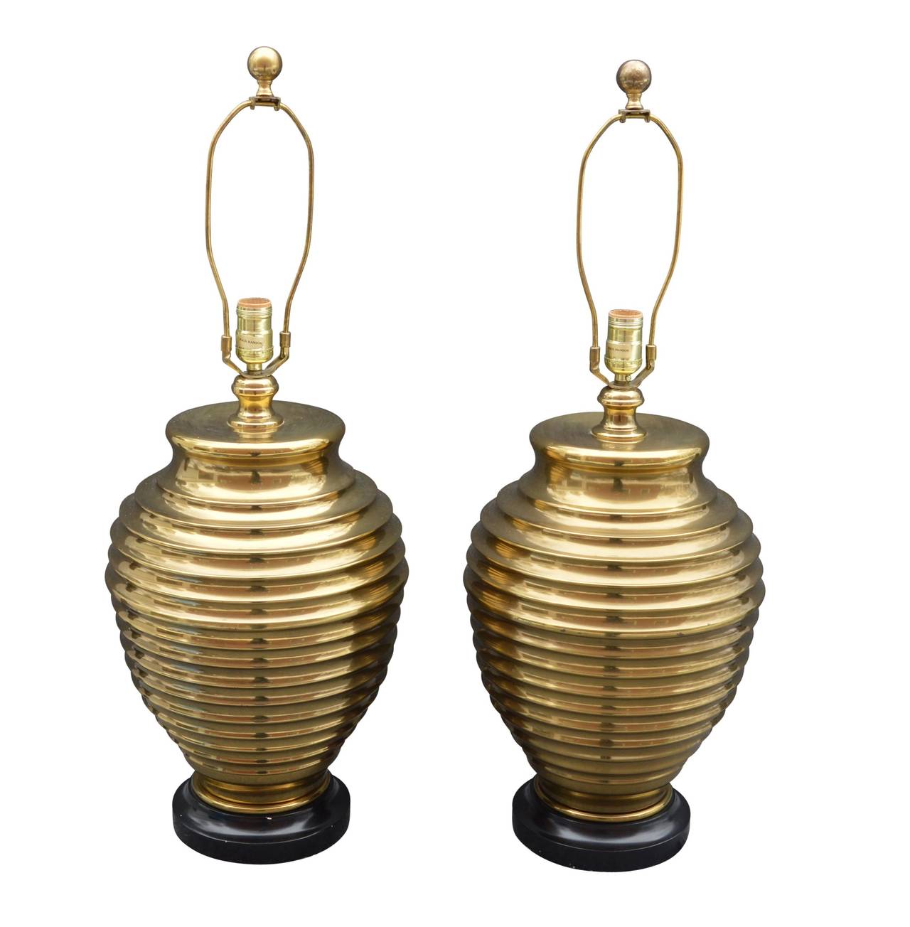 Vintage pair of brass table lamps in sharp and elegant beehive shape on a wooden foot. Very sturdy and relatively heavy, however they can be weighted further if need be.