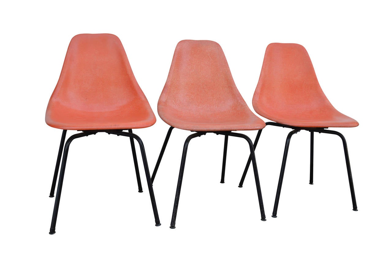 Set of three (2+1) orange fiberglass slipper chairs. Shells are in good condition.