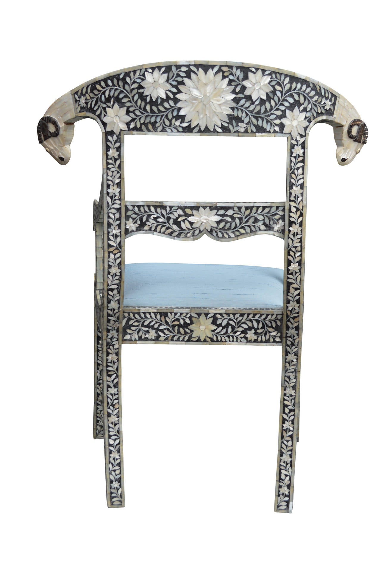 Mother-of-pearl inlaid armchair with ram's head.
Newly upholstered with Azure blue fabric.