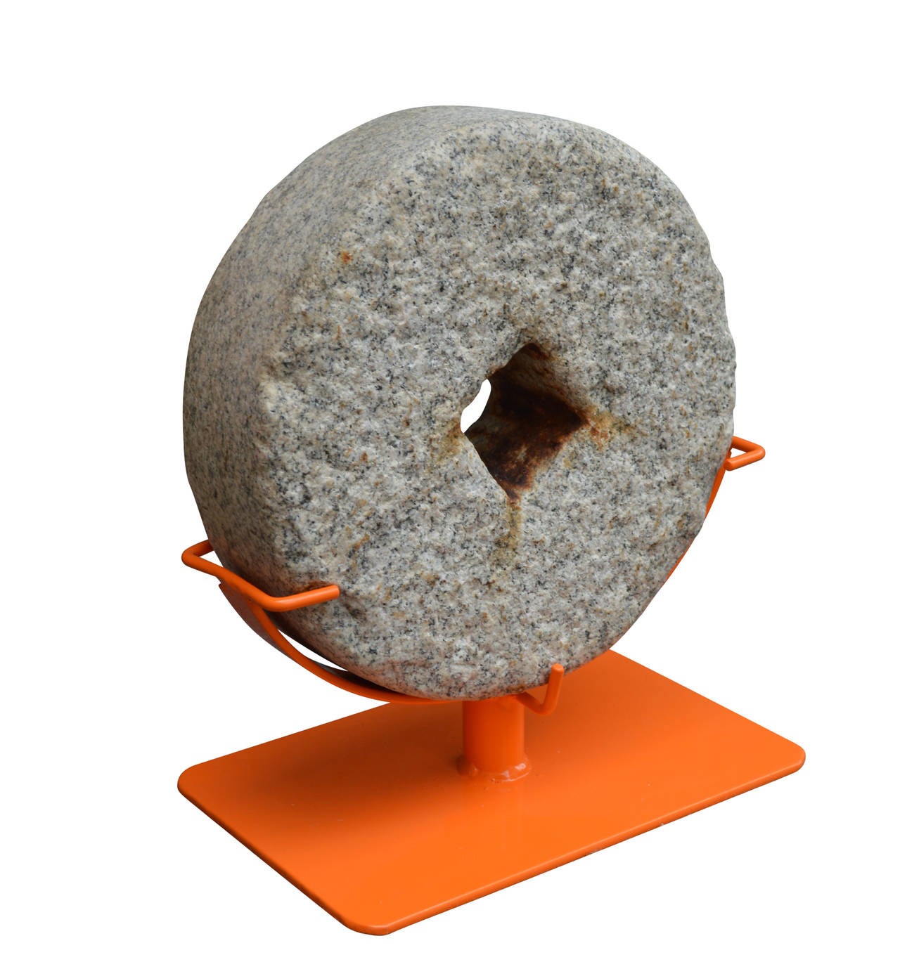 A fine mill-stone with a square mount on a bold modern orange Stand.