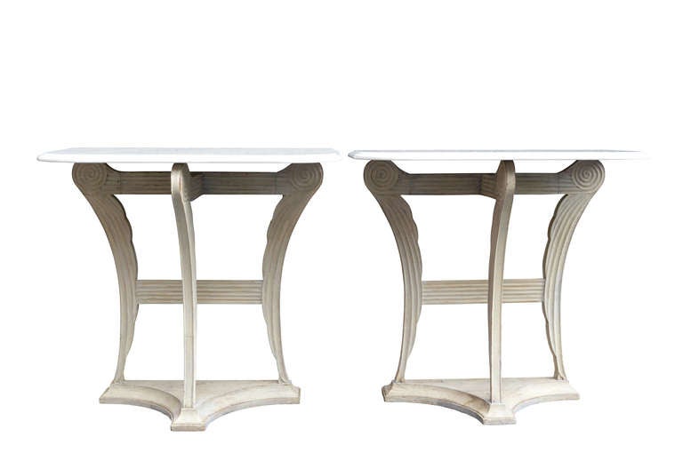Pair of painted angel wing consoles with marble tops.