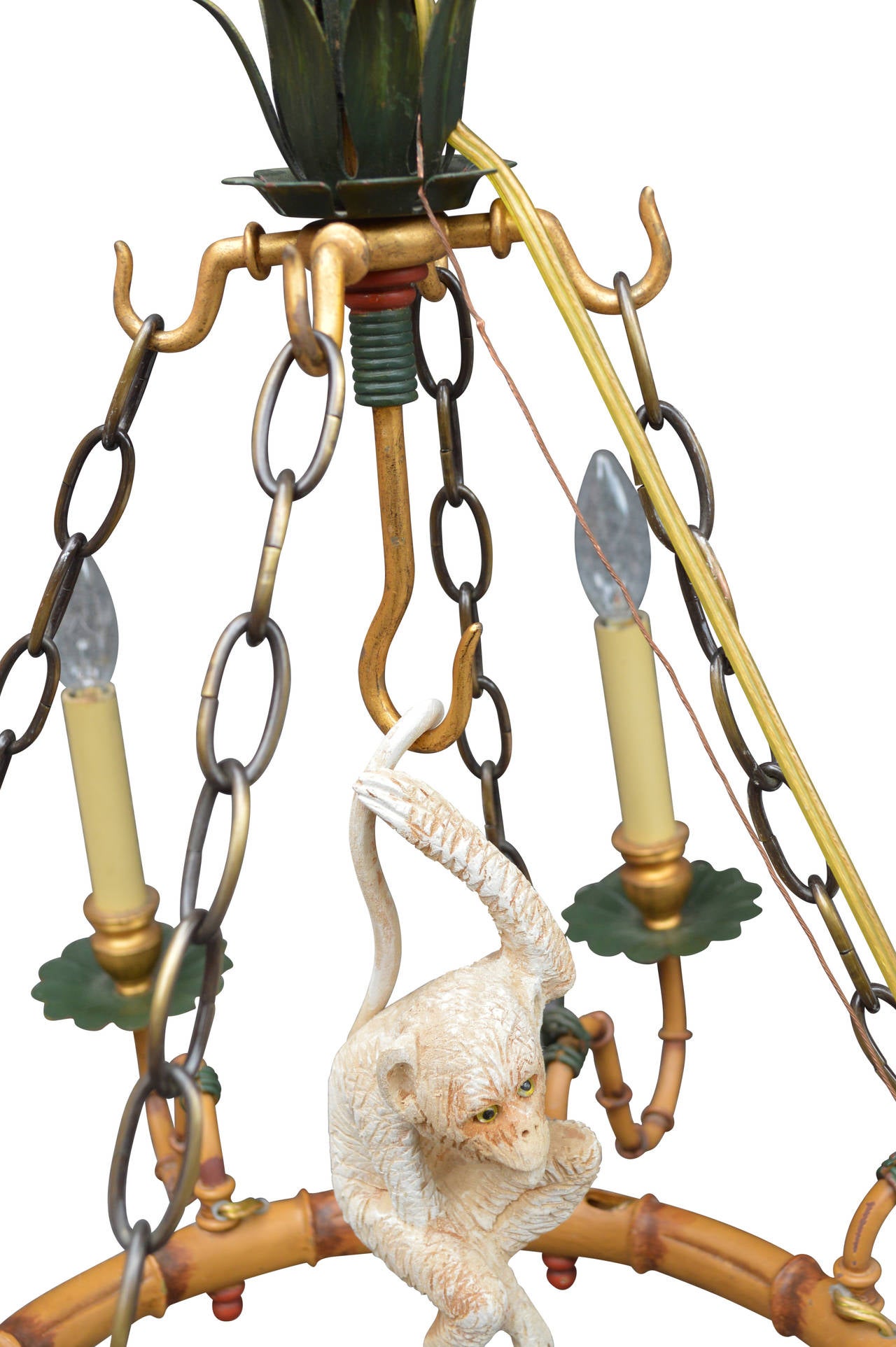An adorable carved wood monkey swings amidst this faux bamboo metal chandelier. Painted to look like natural tan bamboo reeds with green leaves and red accents. Eight candle arms use standard candelabra bulbs. Ready for hardwiring.