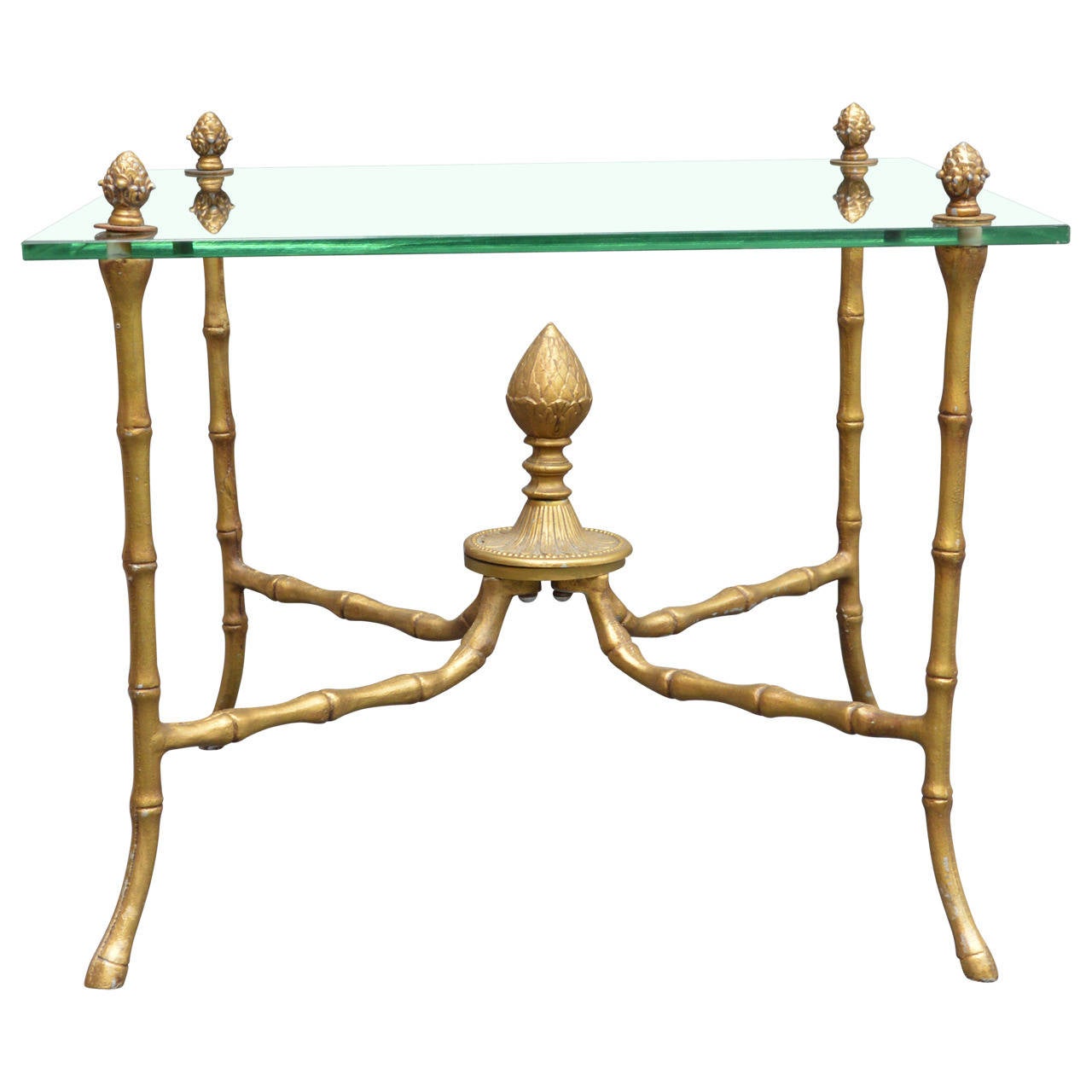 Nicely gilded faux bamboo brass and glass side table with pineapple accents and cloven feet.