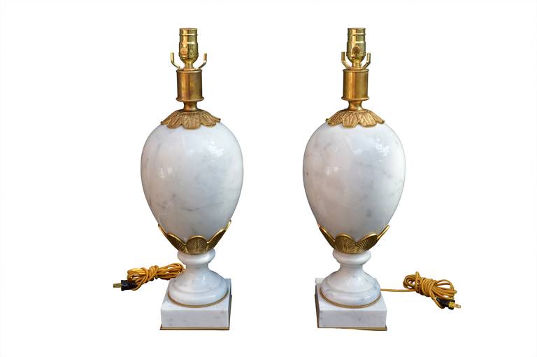 Pair of large solid Italian marble egg-shaped lamps on solid square base. Newly rewired.
