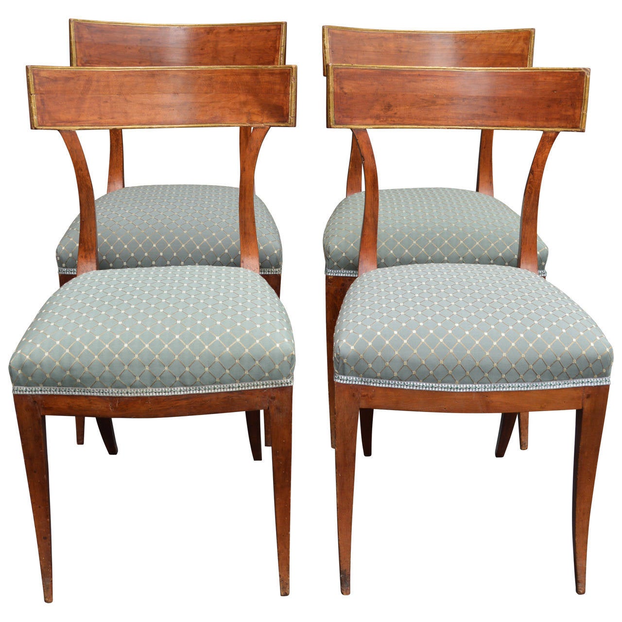 Stunning set of four Directoire style curved back walnut chairs with gilded gold detailing. Newly upholstered in a teal embossed diamond pattern rayon/poly blend.