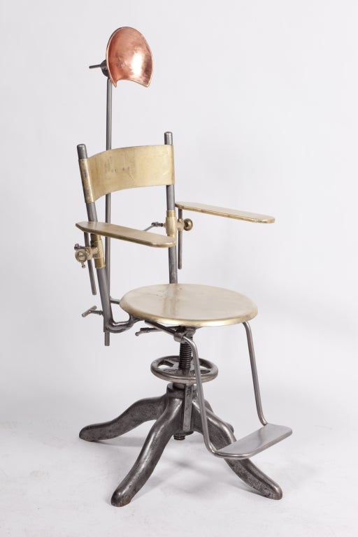Fascinating adjustable dental (?) chair in three different brushed metals.
