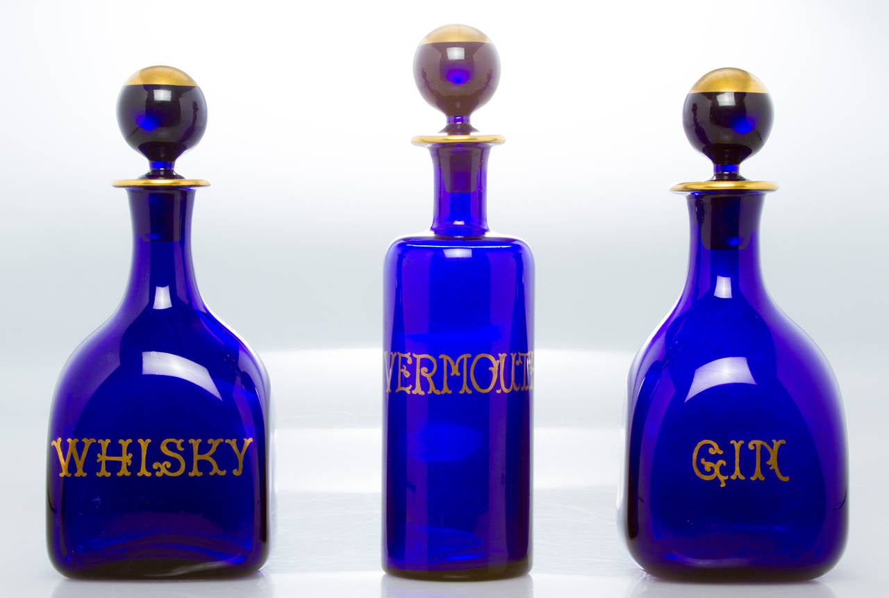 These have a deep blue color and are hand blown.  Each has gold lettering and gold accents.