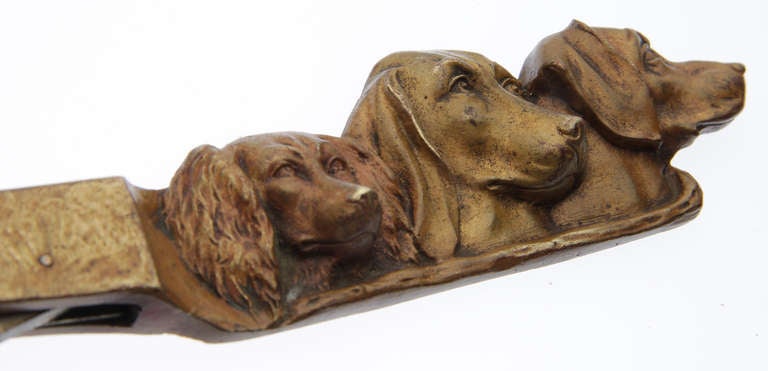 Depicting three dogs, this piece is quite handsome.
