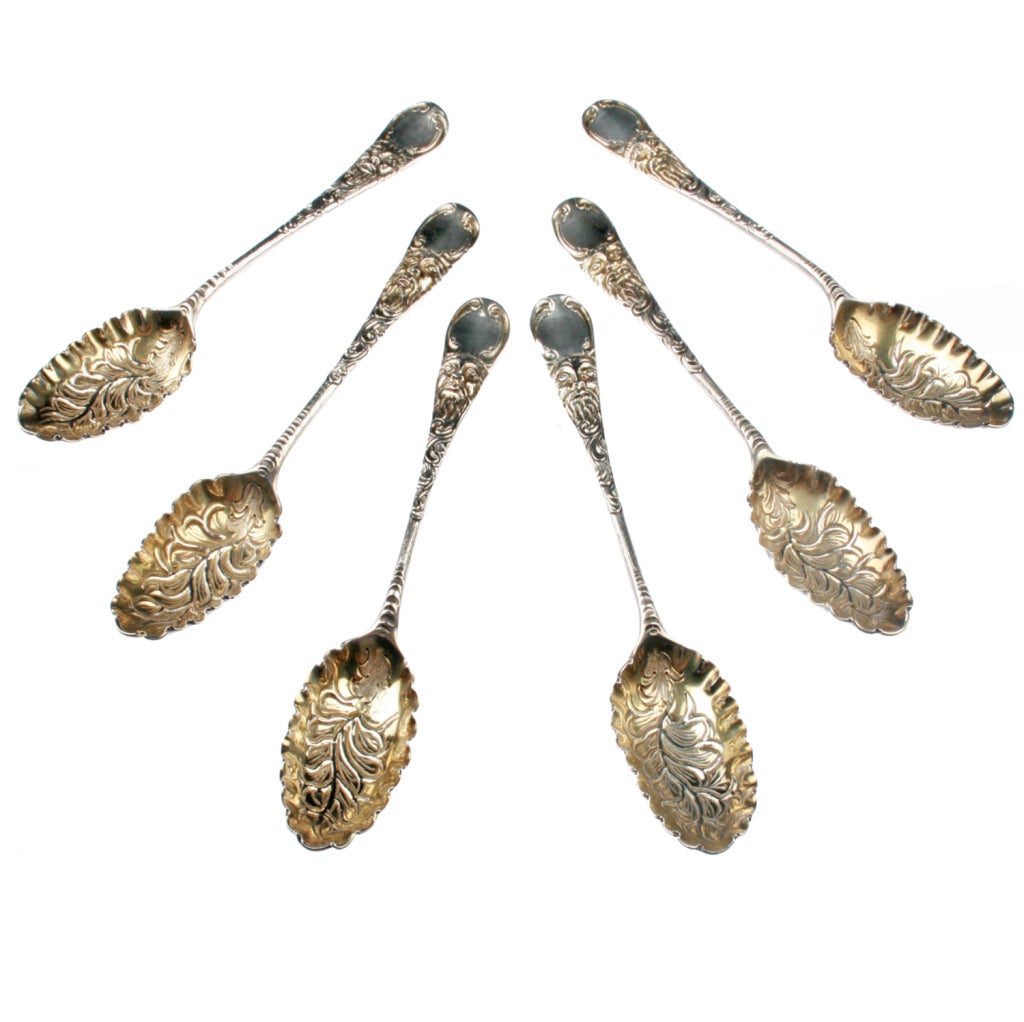 These Six berry Spoons were made by Eben Coker in London in the 1750's. They have a stylized greenman face and heavy stamping and repousee work. They are sold in their original silk lined box.