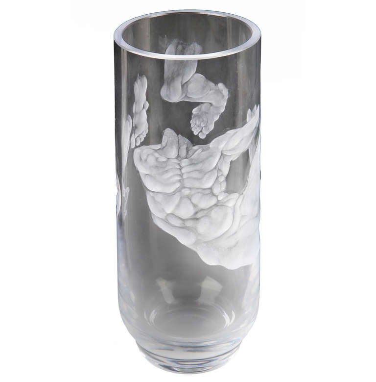 Here is what may be an experimental or practice piece done by a glass artist. I believe it may be made by an Orrefors artist as it is very similar to ones designed by them.  Parts of the male torso encircle the  vase in a surreal way

Absolutely