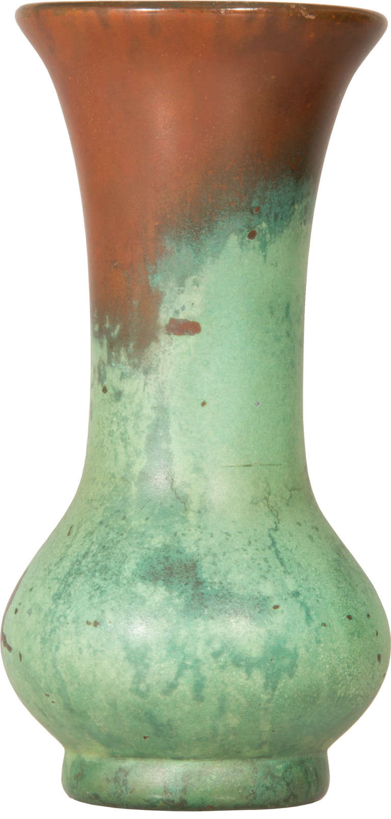This is a vase  by  Charles Clewell.  Originally a metal worker,  he developed a glaze that looks like oxidized copper...a secret  formula that he took to the grave.