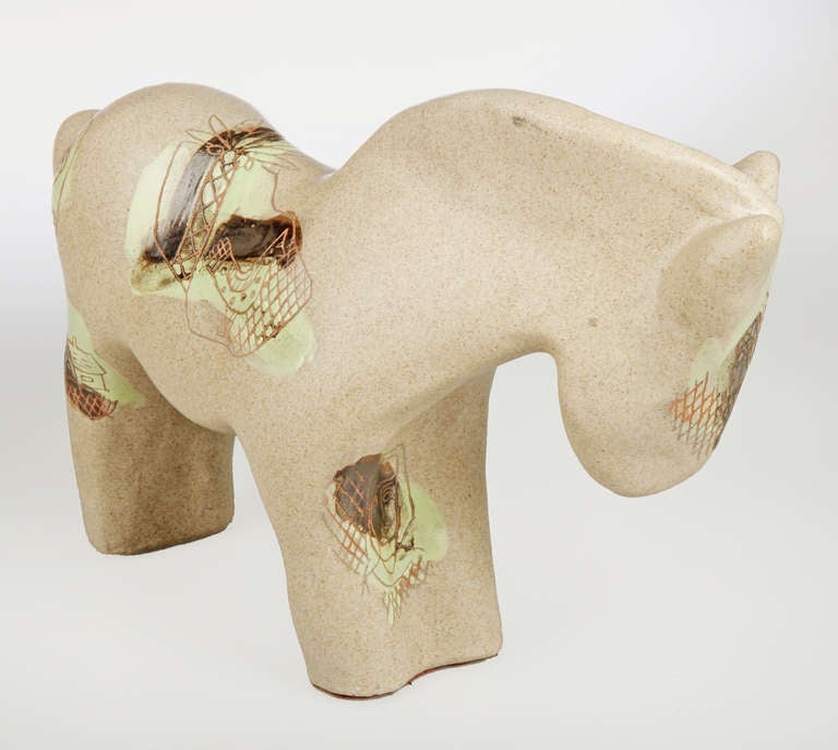 This is a charming glazed terra cotta sculpture of a horse. The sculpture is Incised with images of faces, animals and abstract designs.

This large and inmpressive sculpture is 14. 5