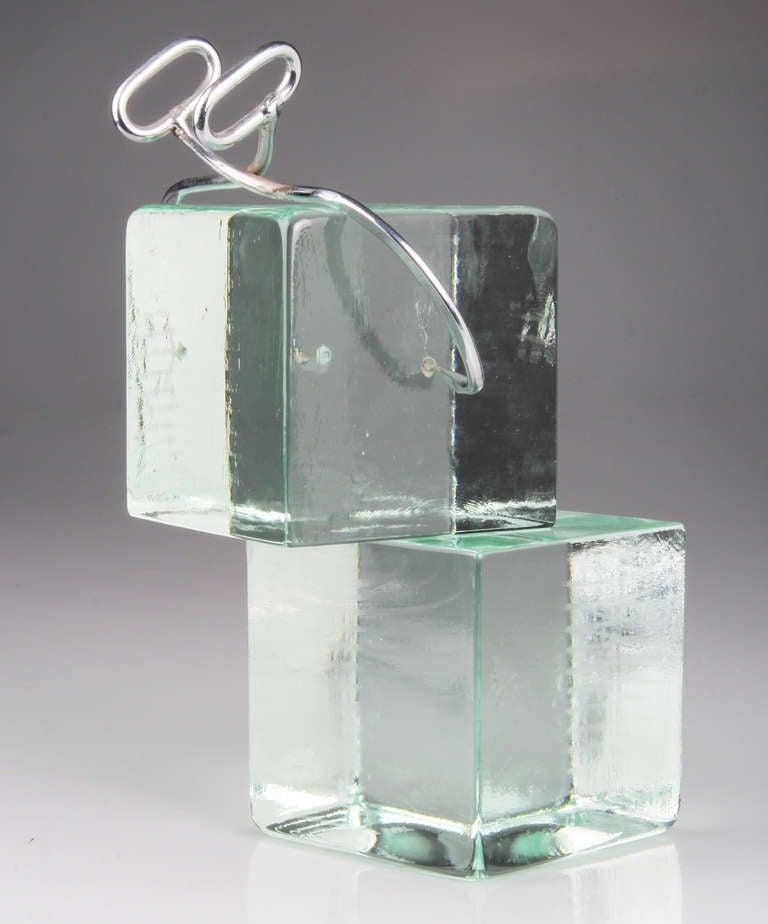 These are handsome, stylish  and substantial bookends by Curtis Jere.  Each glass ice block measures 5 inches square.  The tongs are affixed to one glass cube.