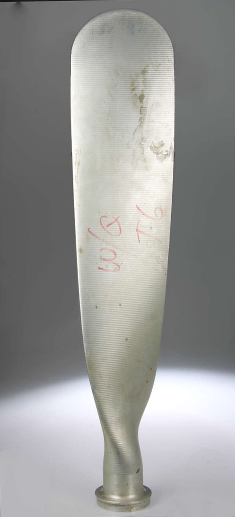 A large fluted aluminum airplane propeller with markings from a machinist or engineer.
T-6 is a specific type of aluminum.
Marked with a Test No.117078, M-1
and Serial Number J19037
the base below the flange measures 4.50 