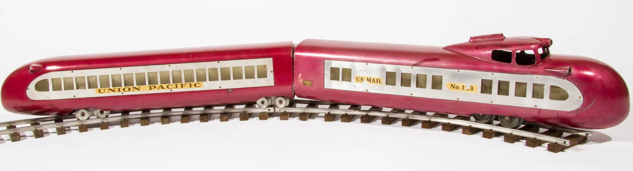 This is a historical piece of train memorabilia and something that comes along only rarely. It is a Union Pacific model toy train, G Gauge electric train M-10000 with three sections, held together by coiled springs. It was originally a prize given