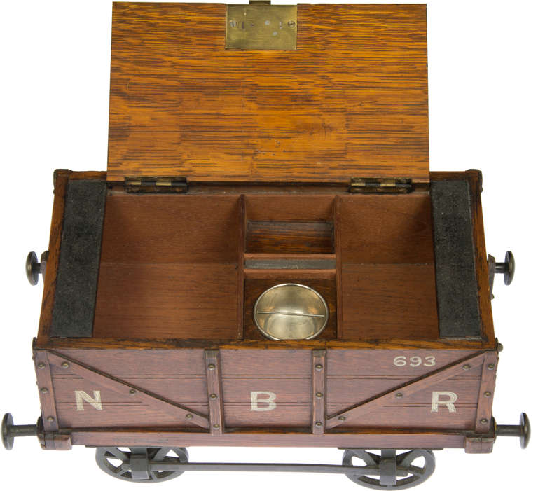 This smoking box is a replica  of a Northern British Railroad Coal Car.
The inside is for cigar's and cigarettes as well as a having a compartment for matches.  Also included is a built in striker, and ashtray and a key.
This is quite a nice