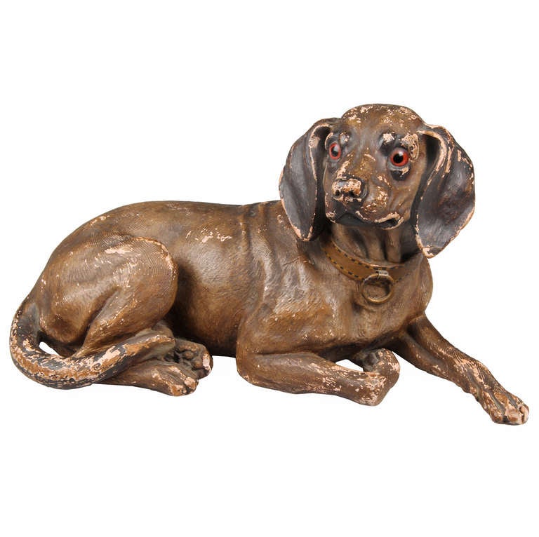 This is a very good sculpture of a Hound dog. He is complete with a leather collar and glass eyes.