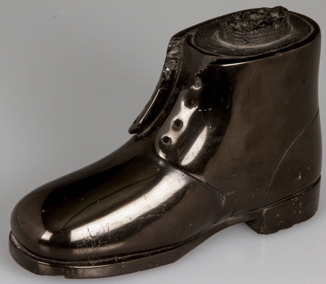 This is a wonderful example of a boot carved out of coal and honed smooth and beautifully detailed. This example is possibly Scottish.