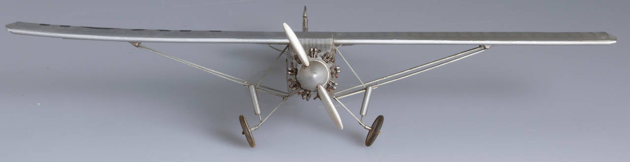 This is a detailed model of the plane that Charles Lindberg soloed across the Atlantic. Through the windows, you can see a detailed cockpit. The plane, Lindberg called the Ryan, NYP. The model has a membrane stretched over a wood frame.