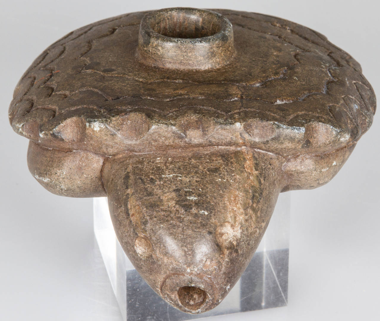 This hand-carved stone pipe has the bowl on the top of the turtles shell with another hole bored through his mouth.