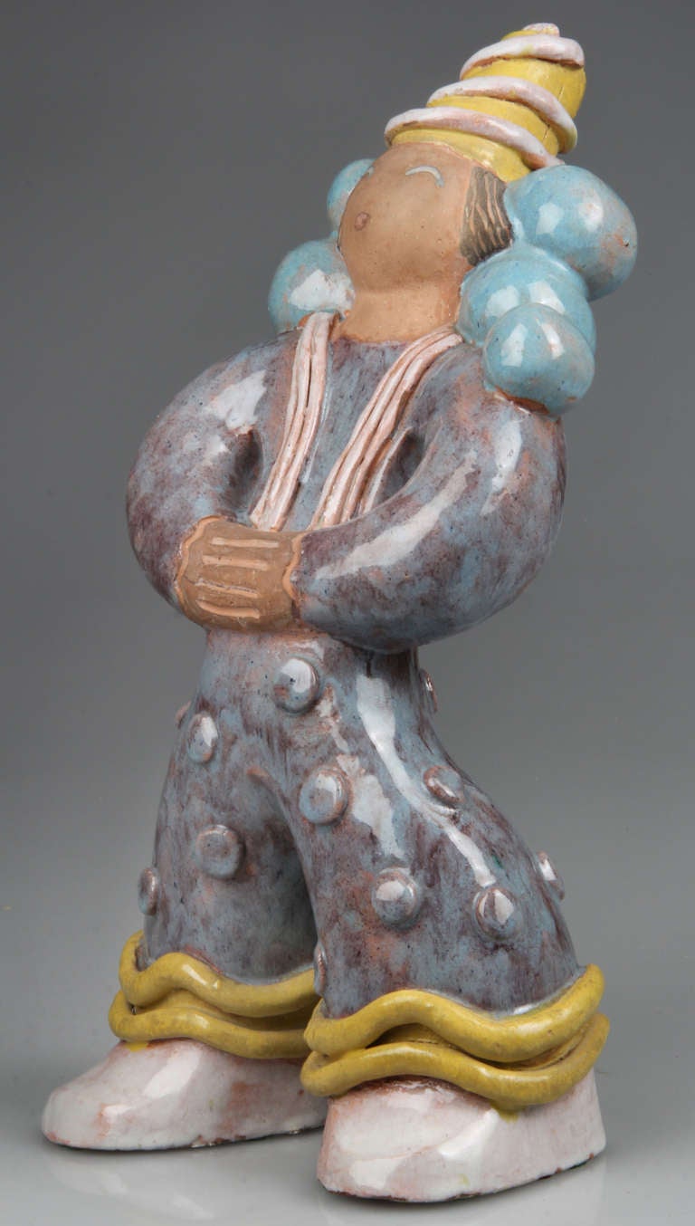 This is a whimsical figurine of a clown or carnie with balloons by Chicago  WPA artist Louise Pain.  It has an almost Weiner Werkstatte feel to it.  Louise Pain created murals and sculpture.