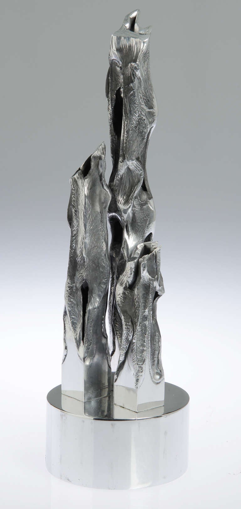 This is an interesting brutalist sculpture, having three flame like
elements. Signed Hibben 71 on the base.