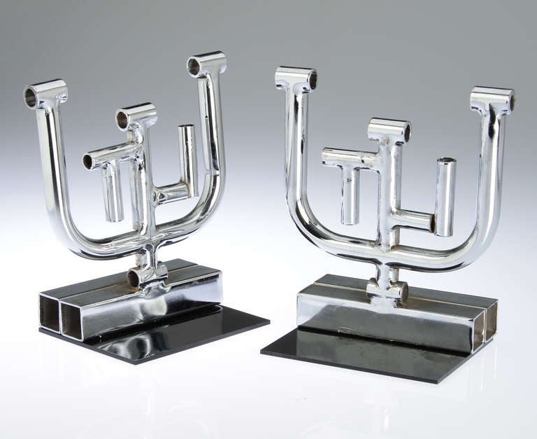 These are great looking sculptural bookends.  They are constructed of chromed tubular steel.

They are 7 inches tall.
The base is 5 x 2 inches and
mounted on a 4 x 5 black acrylic base.