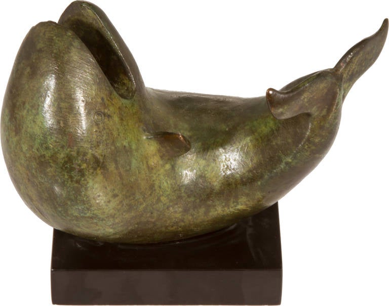 This is an abstracted small  bronze sculpture of a whale by artist Joe McDonnell.  McDonnell creates the majority of his sculptures for public spaces and has an extensive list of installations  as well as exhibitions.