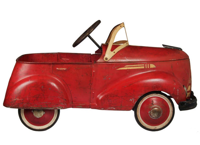 This pedal  car comes complete with red painted hubcap tires.
In original condition, it is by the Garton Toy Company of Sheboygan Wisconsin.