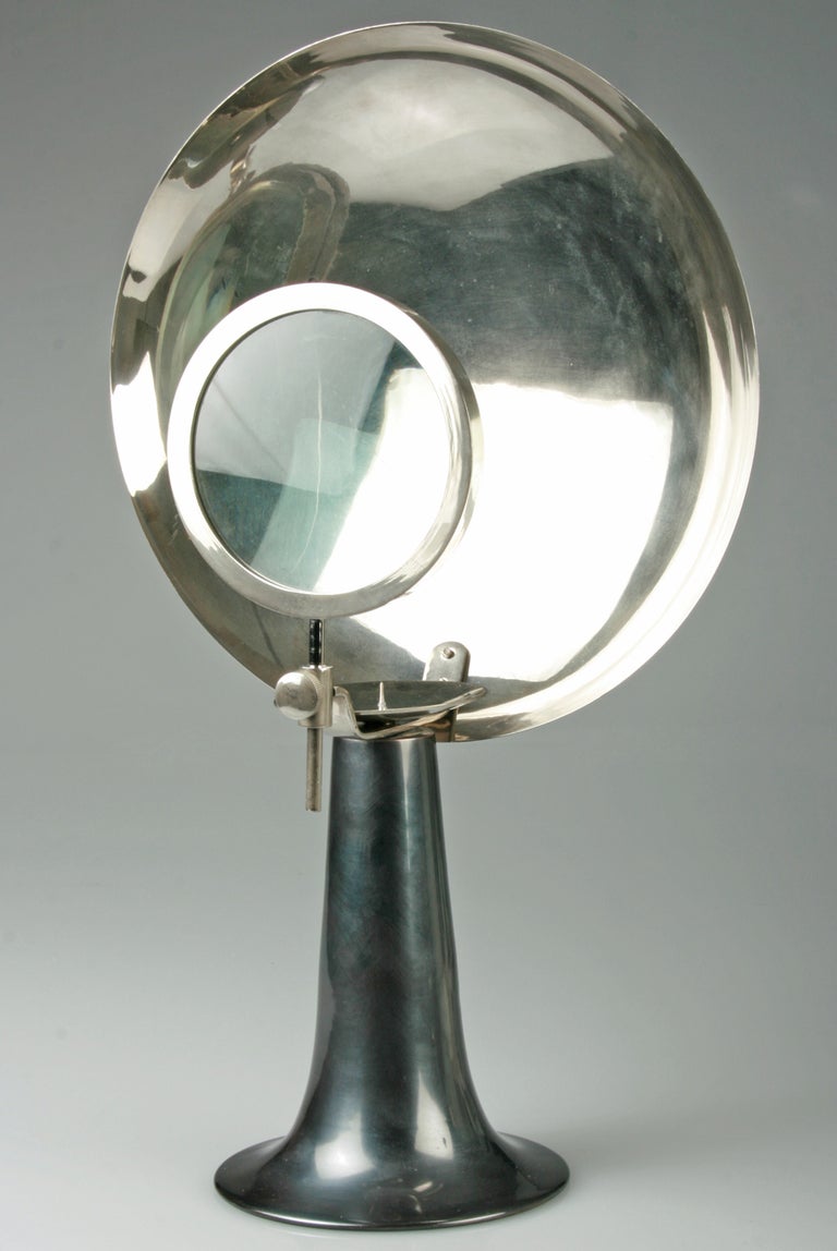 An unusual medical  or scientific instrument utilizing a candle, parabolic reflector and an adjustable magnifying glass. The interior of the reflector is highly polished. The magnifying glass shifts upward and downward with the use of the turn