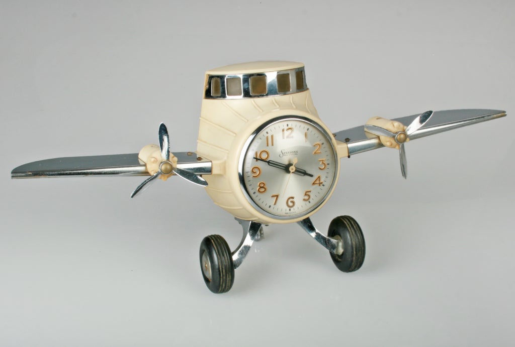 This is a wonderful electric clock in the form of a motorized airplane. The cockpit lights up by turning a switch. Both Propellers turn...the wheels are made of rubber. The windshield, propellers, landing gear and wings are made of metal. Marked