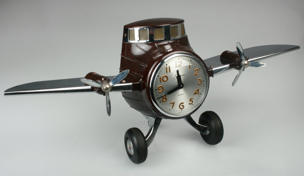 Wonderful electric clock in the form of a motorized airplane. The cockpit light up by turning a switch. Both Propellers turn...the wheels are made of rubber. The windshield, propellers a, landing gear and wings are made of metal. Marked with a