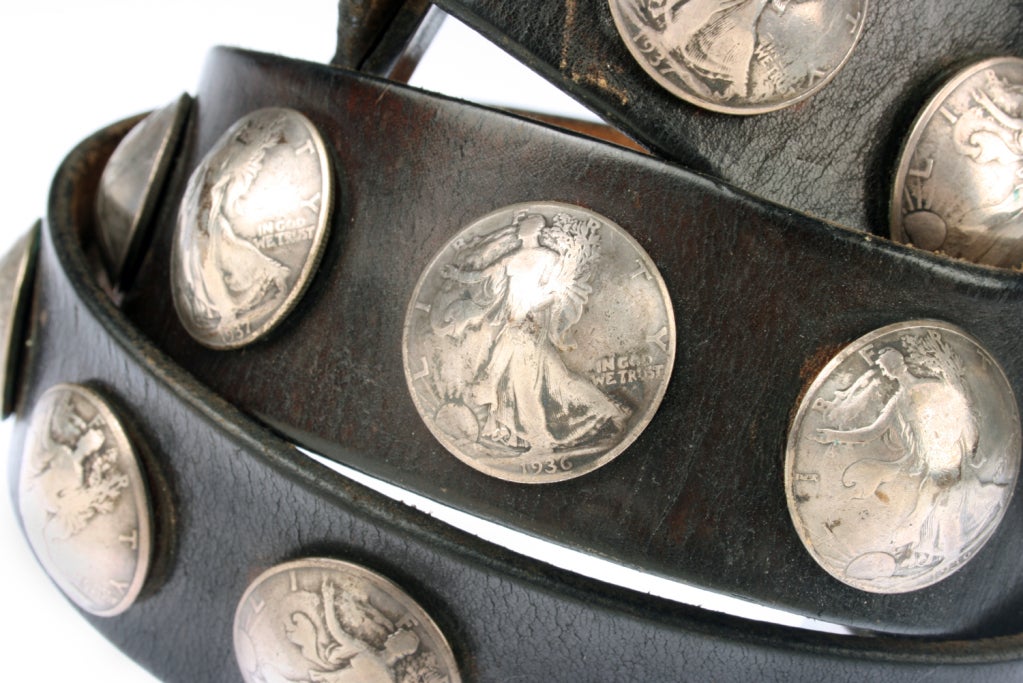This is a Navajo belt with domed Silver Half Dollars or Conchos. It has 21 Conchos dating from 1917 thru 1939. It is an original Harness leather belt. The smallest hole is 35