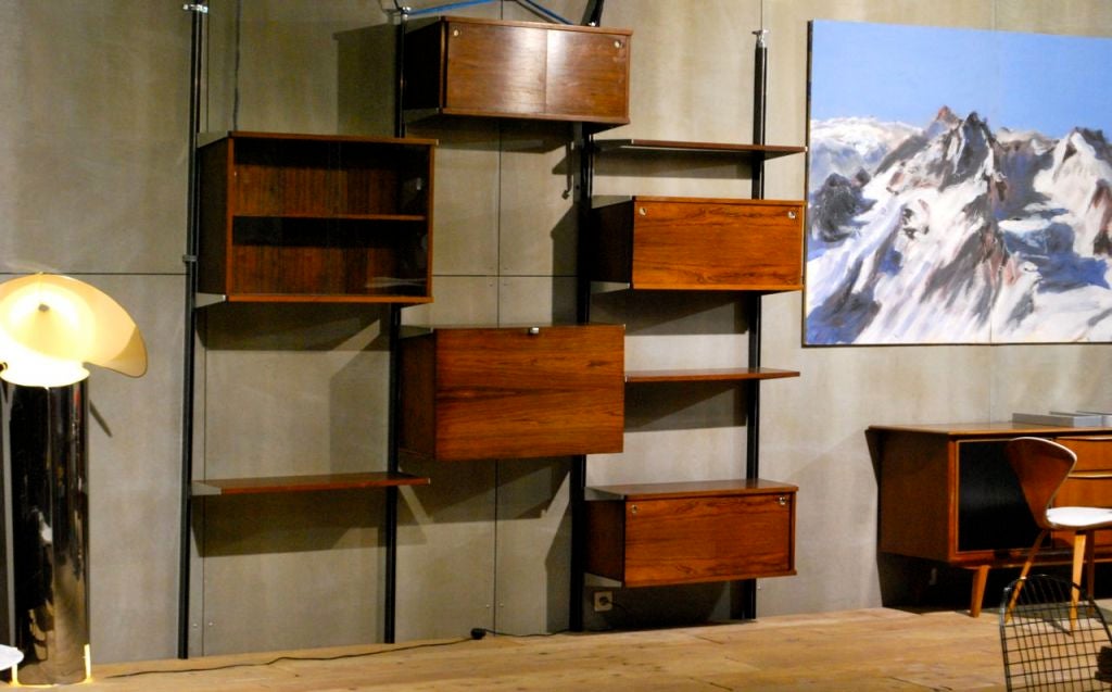Impressive example of George Nelson's CSS storage system for Mobilier International . The system consists of 5 cabinets and 3 shelves. One cabinet includes a flip down desk  The cabinets and shelves may be reconfigured as desired.