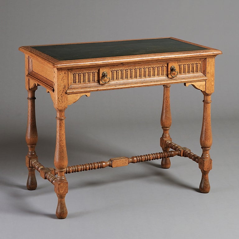 A FINE EDWARDIAN OAK WRITING TABLE DESIGNED BY F.L PEARSON FOR WILLIAM ASTOR AT HEVER CASTLE, CIRCA 1905.
