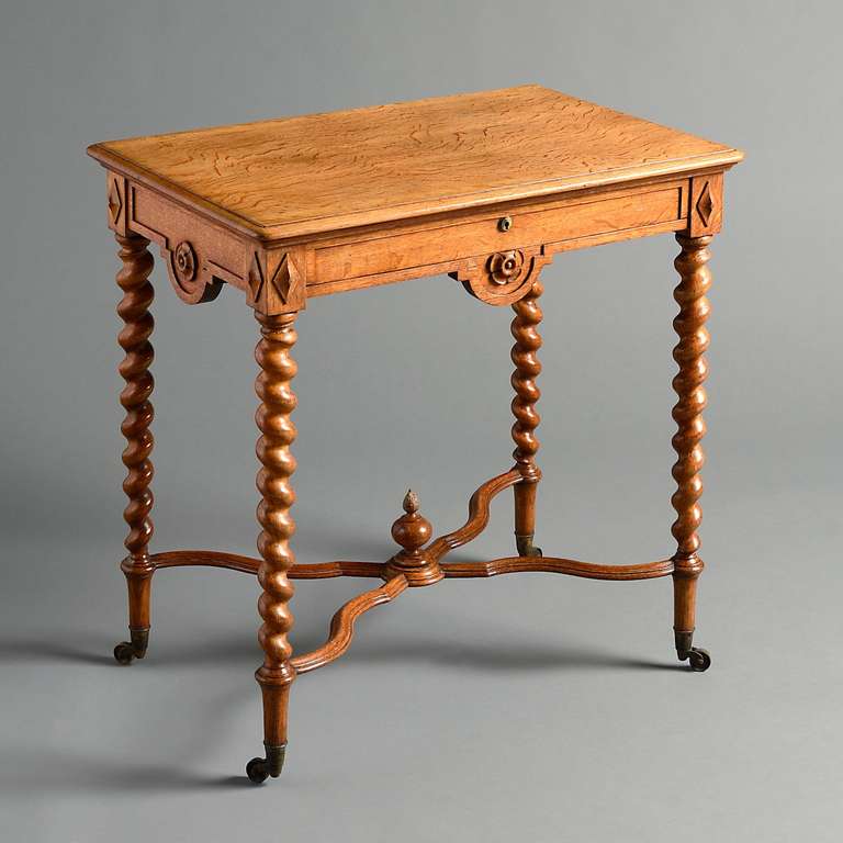 an unusual early Victorian oak table, the frieze applied with lotus paterae on twisted tapering legs joined by shaped stretchers, circa 1840.
