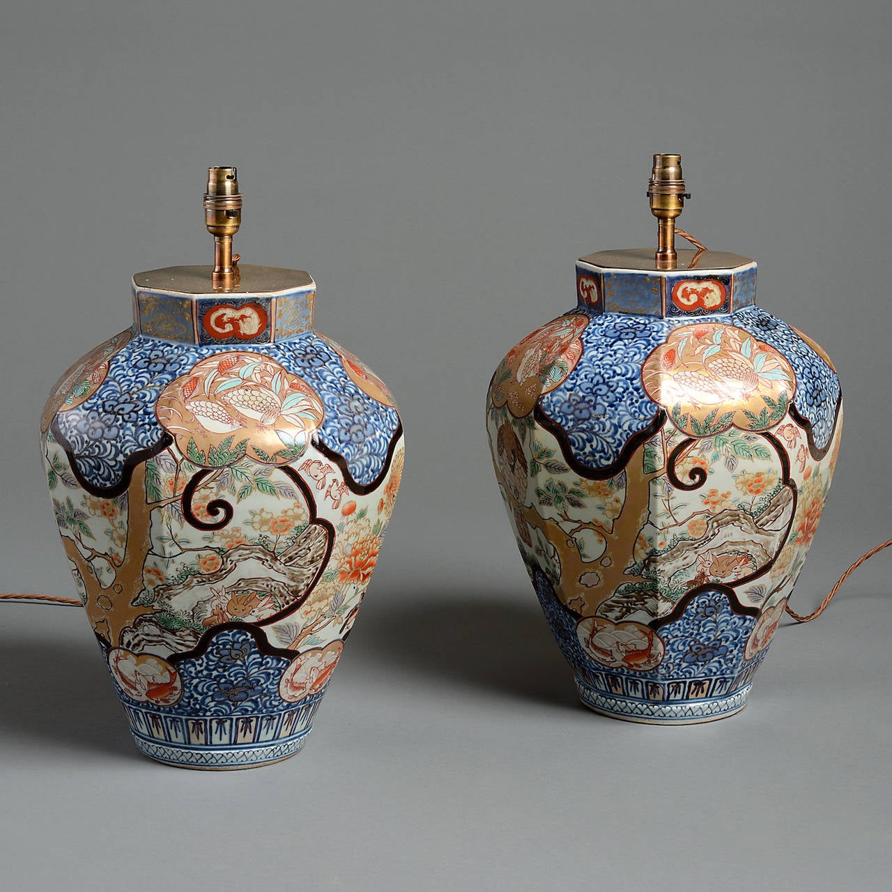 A fine pair of Japanese Imari faceted vase lamps decorated with falcons, quail and flowering foliage, circa 1860.