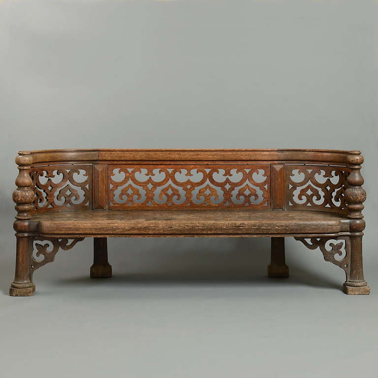 A PAIR OF EARLY VICTORIAN ELIZABETHAN-REVIVAL OAK BENCHES IN THE MANNER OF ANTHONY SALVIN, CIRCA 1840. 
Each with carved back with pierced strapwork panels above solid seats on turned supports with pierced brackets.