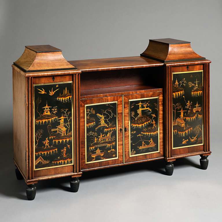 A FINE AND UNUSUAL REGENCY MAHOGANY AND JAPANNED SIDE CABINET BY CHARLES SAWYER, CIRCA 1814.

The inverted breakfront top with pagoda plinths above a bookshelf with concealed drawer behind the four doors with Japanned panels within gilt-brass