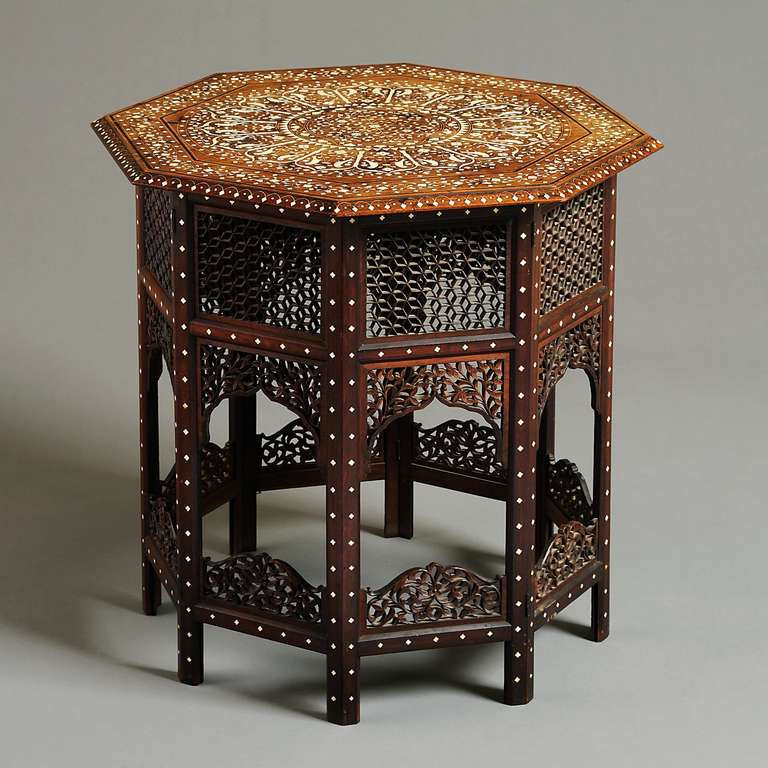 A FINE ANGLO-INDIAN IVORY INLAID OCTAGONAL TABLE, THE TOP INLAID WITH BIRDS AND SCROLLING FOLIAGE, THE BASE WITH INTRICATELY PIERCED PANELS, HOSHIAPUR, CIRCA 1890.