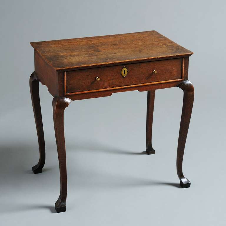 a fine George I oak lowboy with square section cabriole legs and pad feet, circa 1720.