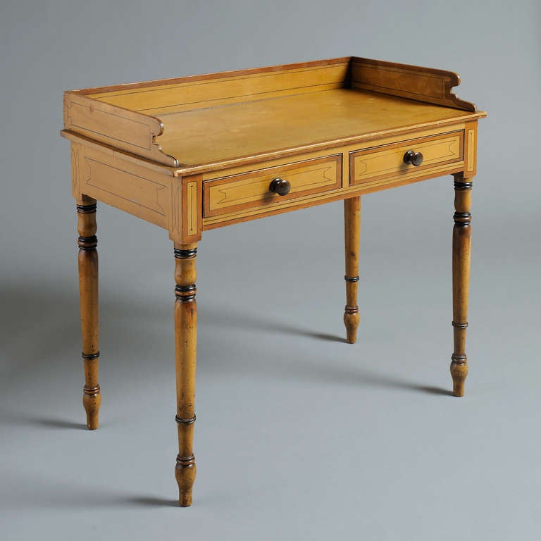 A LATE REGENCY BUFF-PAINTED DRESSING-TABLE, ORIGINAL DECORATION, circa 1820.
