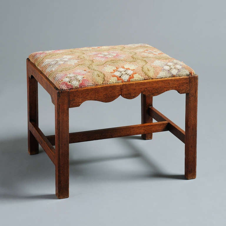 A George III scottish mahogany stool with contemporary needlework seat, circa 1760. 