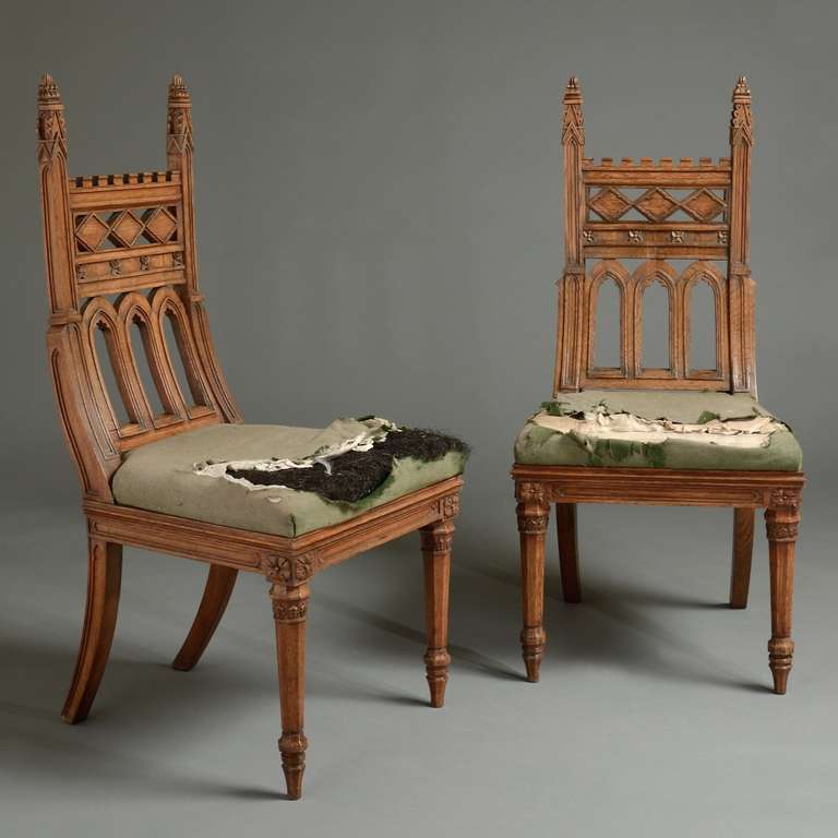 AN EXCEPTIONAL PAIR OF GEORGE IV OAK GOTHIC-REVIVAL CHAIRS AFTER A DESIGN BY MICHAEL ANGELO NICHOLSON, CIRCA 1826.
These remarkable chairs exactly follow Michael Angelo Nicholson’s design in 'The Carpenter and Joiner’s Companion' of 1826.
