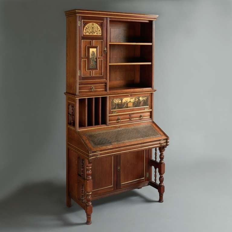 An aesthetic movement parcel-gilt walnut bureau by Gillows, the design attributed to H.W. Batley, circa 1880. Stamped: Gillow & Co. 12117.<br />
The upper section with gilt-ground panels painted with flowers and historical scenes, the base inset