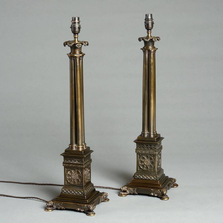 A pair of Regency bronze lamps by Francis Hardenberg with leaf and flower head capitals on cluster columns, the square plinths decorated with tracery, on chimera feet, circa 1805. 

Francis Hardenberg (active 1783, died 1852) supplied lamps of