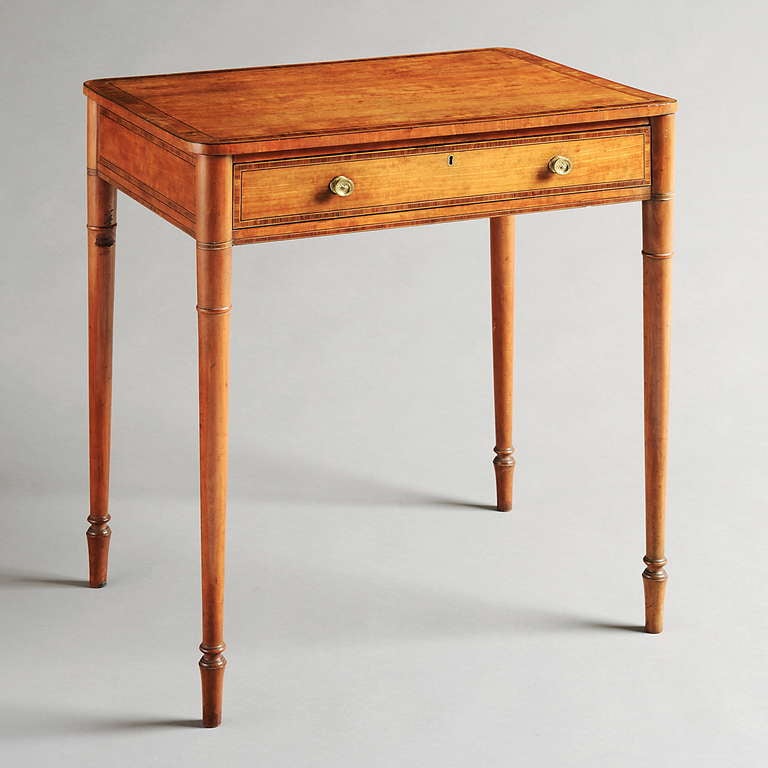 A GEORGE III SATINWOOD AND TULIPWOOD-BANDED WRITING-TABLE ATTRIBUTED TO JAMES NEWTON, Circa 1800.